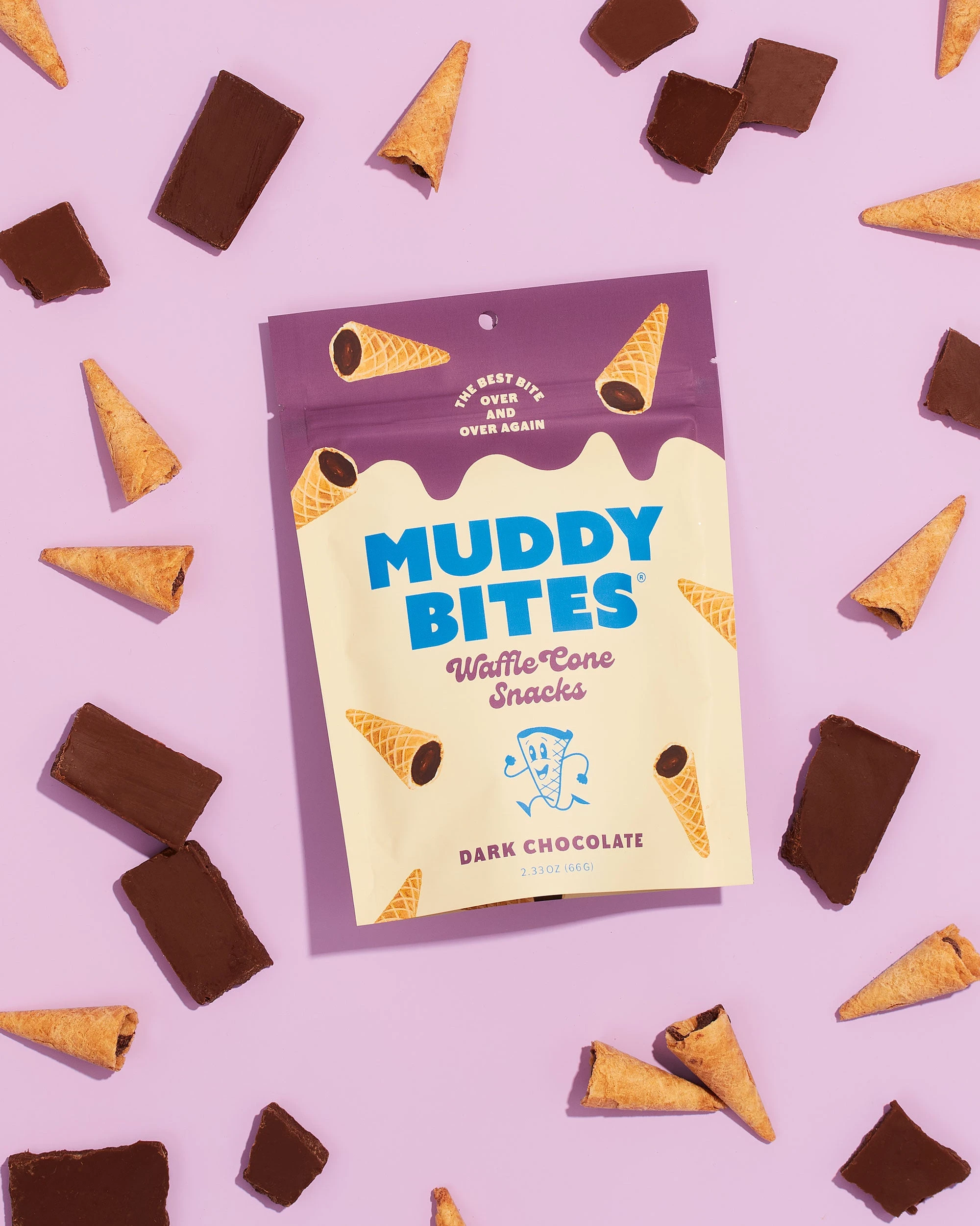 Dark Chocolate Muddy Bites bag surrounded by cones and chocolate on lilac